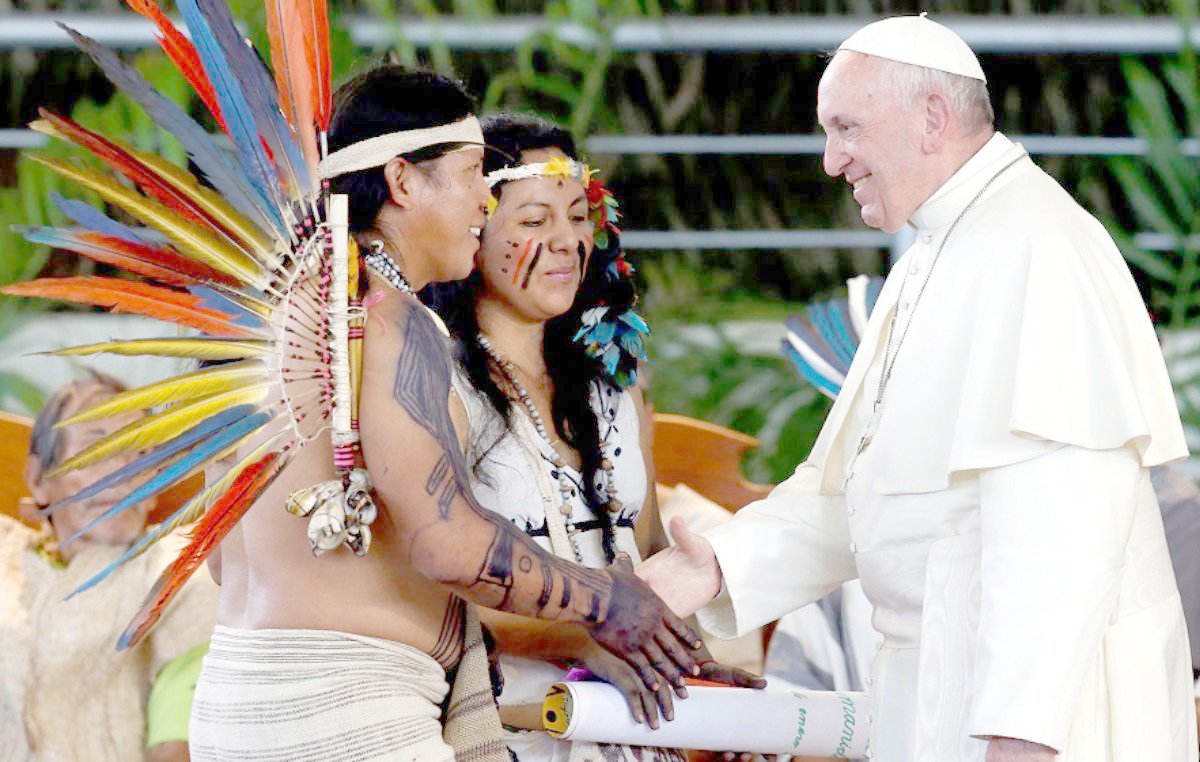 Pope Francis greets members of an indigenous group from the Amazon region, in Puerto Maldonado