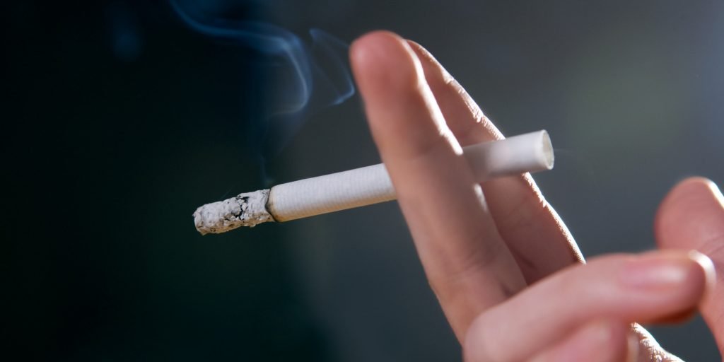 Woman's fingers with smoking cigarette